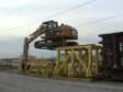 Cat 319D LN climbing onto rail car